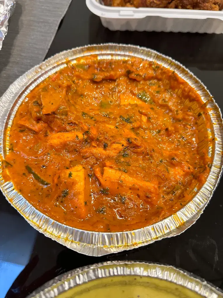 Traditional Gulab Jamun dessert at Green Chili Delight Calgary, AB